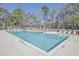 Large outdoor swimming pool with lounge chairs surrounded by lush greenery at 7965 Edgebrook Cir # F, North Charleston, SC 29418