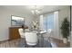 Staged dining room with a round table, marble top, and a modern chandelier at 7965 Edgebrook Cir # F, North Charleston, SC 29418