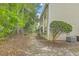 Side view of a two-story home with an air conditioning unit and mature trees at 7965 Edgebrook Cir # F, North Charleston, SC 29418