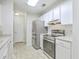 Bright kitchen with stainless steel appliances, granite countertops, and white cabinets at 7965 Edgebrook Cir # F, North Charleston, SC 29418