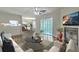 Bright, open-concept living room with fireplace, dining area, and sliding glass door creates a welcoming space at 7965 Edgebrook Cir # F, North Charleston, SC 29418