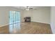 Spacious living room boasts a fireplace, access to a sunroom, and beautiful hardwood flooring at 7965 Edgebrook Cir # F, North Charleston, SC 29418