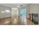 Large living room boasts fireplace, hardwood floors, and glass doors to backyard at 7965 Edgebrook Cir # F, North Charleston, SC 29418