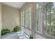 This sunroom is filled with windows and plants at 7965 Edgebrook Cir # F, North Charleston, SC 29418