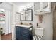 This bathroom features a blue vanity, a large mirror, and updated fixtures at 801 Reserve Way, Summerville, SC 29485