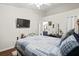 This bedroom boasts a TV, wood floors, and a comfortable bed with soft pillows at 801 Reserve Way, Summerville, SC 29485