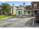 Exterior view of yellow home with parking spaces in front and mature trees surrounding the property at 801 Reserve Way, Summerville, SC 29485