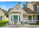 Charming yellow home featuring a well-manicured front yard, front porch, and bay window at 801 Reserve Way, Summerville, SC 29485