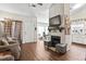 Open-concept living room featuring a white fireplace, hardwood floors, and lots of natural light at 801 Reserve Way, Summerville, SC 29485