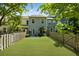 Spacious backyard featuring a well-maintained lawn, a privacy fence, and an outdoor seating area, perfect for relaxation at 849 Bibury Ct, Charleston, SC 29414