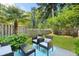Inviting backyard with patio furniture, lush greenery, and a privacy fence at 849 Bibury Ct, Charleston, SC 29414