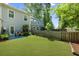 Spacious backyard featuring a well-maintained lawn, a privacy fence, and an outdoor seating area, perfect for relaxation at 849 Bibury Ct, Charleston, SC 29414