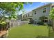 Spacious backyard featuring a well-maintained lawn, a privacy fence, and an outdoor seating area, perfect for relaxation at 849 Bibury Ct, Charleston, SC 29414