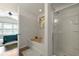 Bathroom featuring a soaking tub, glass-enclosed shower, and an open doorway to a bedroom at 849 Bibury Ct, Charleston, SC 29414