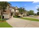 Charming two-story townhouse with a stone and siding facade, a well-manicured lawn, and a private driveway at 849 Bibury Ct, Charleston, SC 29414