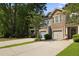 Desirable two-story townhome with stone facade, convenient attached garage, and well-maintained landscaping at 849 Bibury Ct, Charleston, SC 29414