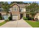 Charming townhome with a stone facade, inviting front porch, and well-manicured landscaping at 849 Bibury Ct, Charleston, SC 29414