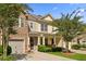 Inviting two-story townhouse with a stone and siding facade, a well-manicured lawn, and an attached one-car garage at 849 Bibury Ct, Charleston, SC 29414