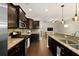 Well-equipped kitchen featuring stainless steel appliances, dark cabinetry, and granite countertops at 849 Bibury Ct, Charleston, SC 29414