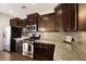 Modern kitchen featuring dark wood cabinets, granite countertops, and stainless steel appliances at 849 Bibury Ct, Charleston, SC 29414