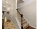 Carpeted staircase leading to the upper level of the home with hardwood floors at 849 Bibury Ct, Charleston, SC 29414