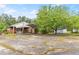 View of the backyard with a covered carport, outbuilding and a large shade tree at 9995 Lodge Hwy, Lodge, SC 29082