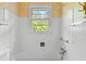 Simple bathroom has a white shower tub and yellow floral wallpaper at 9995 Lodge Hwy, Lodge, SC 29082