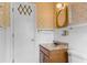 Cozy bathroom featuring patterned wallpaper and wood-finish vanity sink at 9995 Lodge Hwy, Lodge, SC 29082