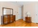 Bedroom with hardwood floors, a dresser, and a view of the yard at 9995 Lodge Hwy, Lodge, SC 29082
