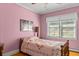 Charming bedroom with pink walls, hardwood floors, and natural light at 9995 Lodge Hwy, Lodge, SC 29082