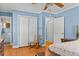 Bright bedroom has hardwood floors with blue walls and an attached bathroom at 9995 Lodge Hwy, Lodge, SC 29082