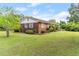 Side view of a brick house with a well-maintained lawn and charming blue shutters at 9995 Lodge Hwy, Lodge, SC 29082