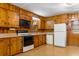 Functional kitchen with wooden cabinets, essential appliances, and a retro charm at 9995 Lodge Hwy, Lodge, SC 29082