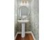 Elegant half bathroom features designer wallpaper, modern fixtures, and hardwood floors at 103 Sylvan Ter, Summerville, SC 29485