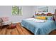 Cozy bedroom featuring hardwood floors, natural light, and a comfortable sleeping area at 103 Sylvan Ter, Summerville, SC 29485