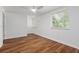 Bright bedroom with laminate floors, ceiling fan, and two windows at 103 Sylvan Ter, Summerville, SC 29485