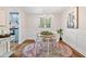 Bright dining room with a round table, white chairs, an eye-catching rug and easy access to the kitchen at 103 Sylvan Ter, Summerville, SC 29485