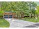 Traditional brick home featuring an attached two-car garage and an expansive driveway lined by a verdant lawn at 103 Sylvan Ter, Summerville, SC 29485