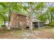 A two-story brick home features a screened in porch, backyard views, and mature trees at 103 Sylvan Ter, Summerville, SC 29485