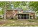 A two-story brick home features a screened in porch, backyard views, and mature trees at 103 Sylvan Ter, Summerville, SC 29485
