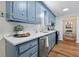Updated kitchen featuring blue cabinets, white countertops, stainless steel appliances, and ample counter space at 103 Sylvan Ter, Summerville, SC 29485