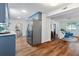 Open-concept kitchen flows into a seating area with blue accent cabinets, stainless steel appliances, and wood floors at 103 Sylvan Ter, Summerville, SC 29485