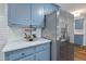 Bright kitchen with blue cabinets, stainless steel refrigerator, and countertops with plenty of room for decor at 103 Sylvan Ter, Summerville, SC 29485