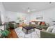 Bright living room with modern ceiling fan, hardwood floors, archway and decorative wainscotting at 103 Sylvan Ter, Summerville, SC 29485