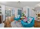 Bright living room with hardwood floors and blue chairs flanking a round table in a stylish arrangement at 103 Sylvan Ter, Summerville, SC 29485
