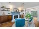 Stylish living area featuring a cozy seating arrangement with blue chairs and a decorative fireplace at 103 Sylvan Ter, Summerville, SC 29485