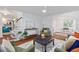 Stylish living room with staircase, modern ceiling fan, hardwood floors, and open floor plan at 103 Sylvan Ter, Summerville, SC 29485