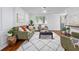 Comfortable living room with a plush green sofa, area rug, lots of natural light, and stylish decor at 103 Sylvan Ter, Summerville, SC 29485