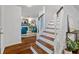 Inviting foyer with a staircase featuring wooden steps and white risers, leading to a cozy living area at 103 Sylvan Ter, Summerville, SC 29485