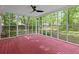 Bright sunroom with a red-painted floor, screened windows, and backyard views provides a relaxing space at 103 Sylvan Ter, Summerville, SC 29485